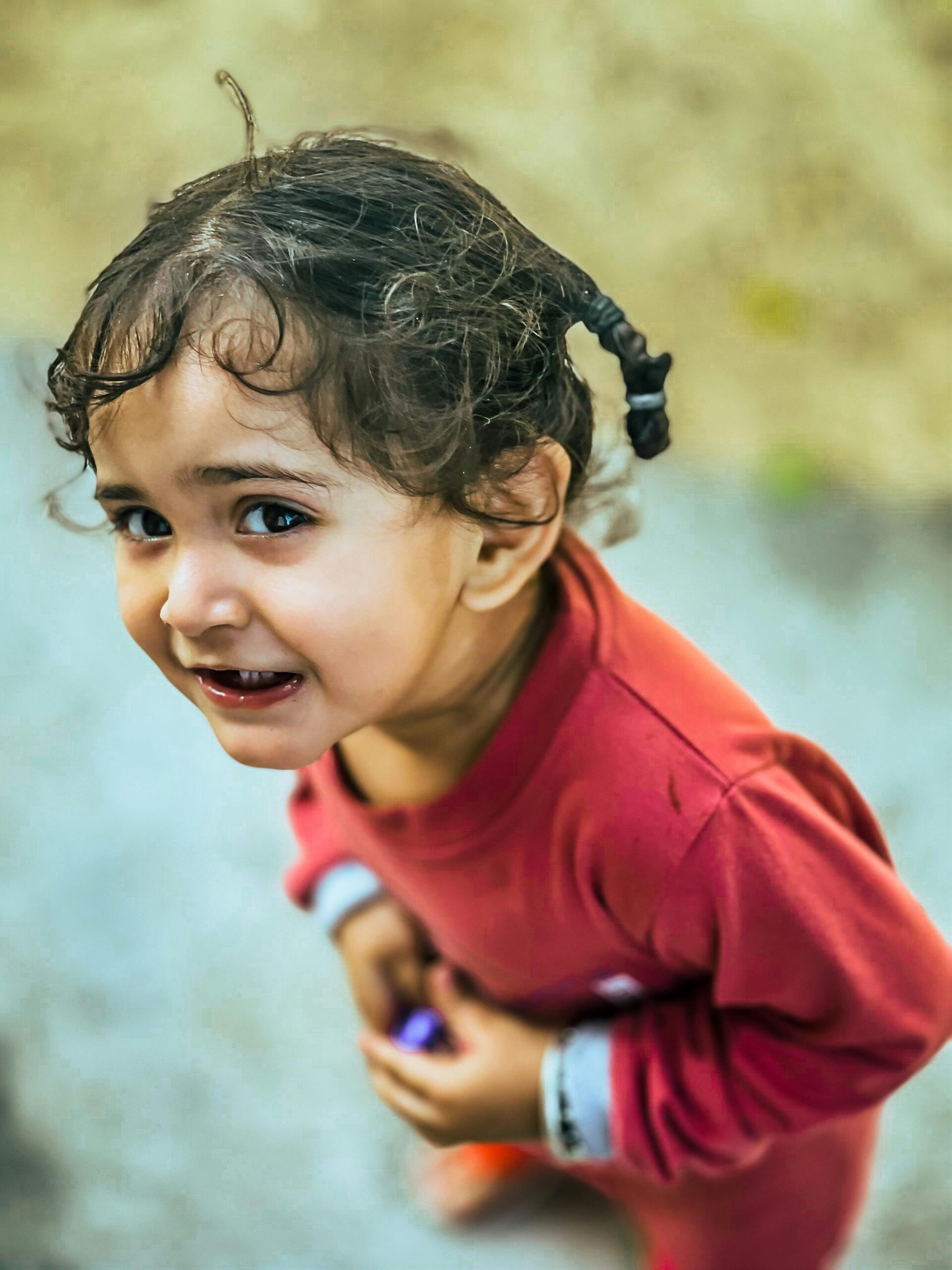 Adorable toddler girl enjoying a delightful moment outdoors in Chandigarh, India.